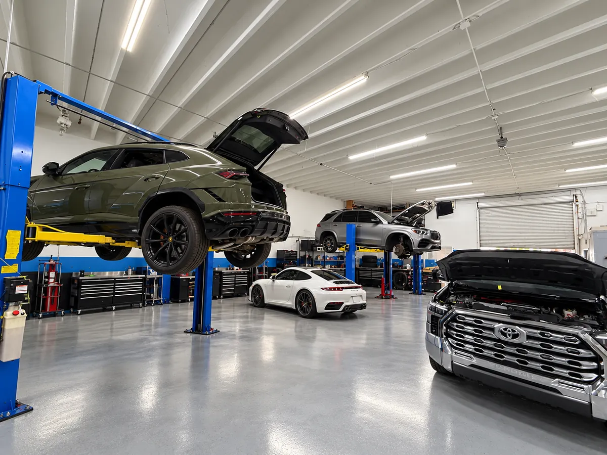 First Rowe Auto shop interior illustration with vehicles on lifts